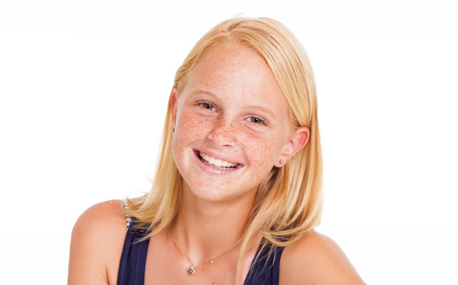 A Girl Smiling With Freckles
