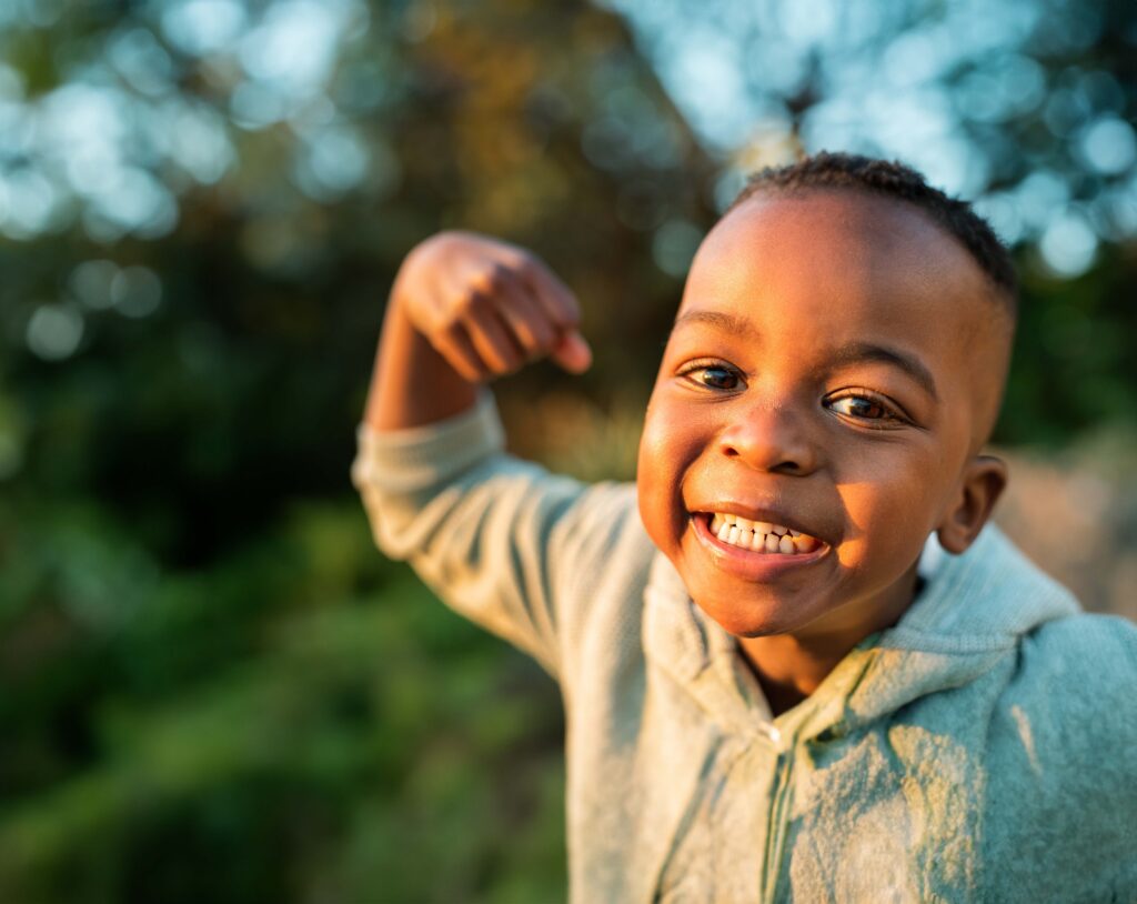 A Young Boy Flexing His Arm