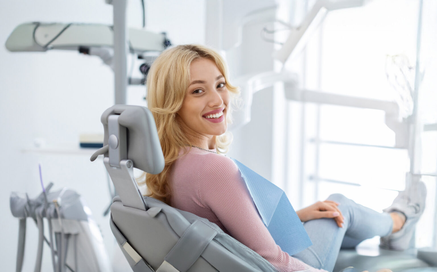 Happy Female Patient In A Dental Chair