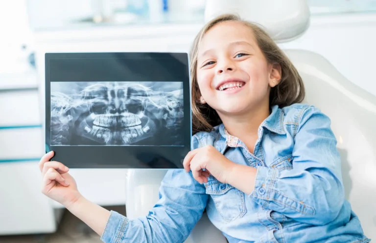 Young Girl Smiling At The Dentist Office Chair